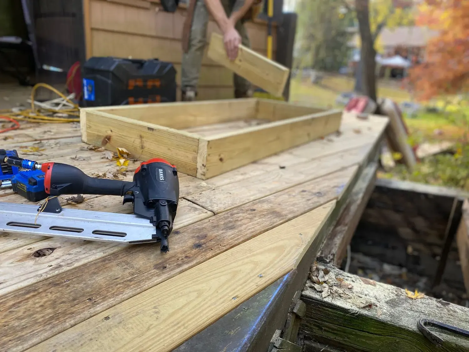 Deck repair in Marietta, GA: new lumber and nail gun on a deck framing job