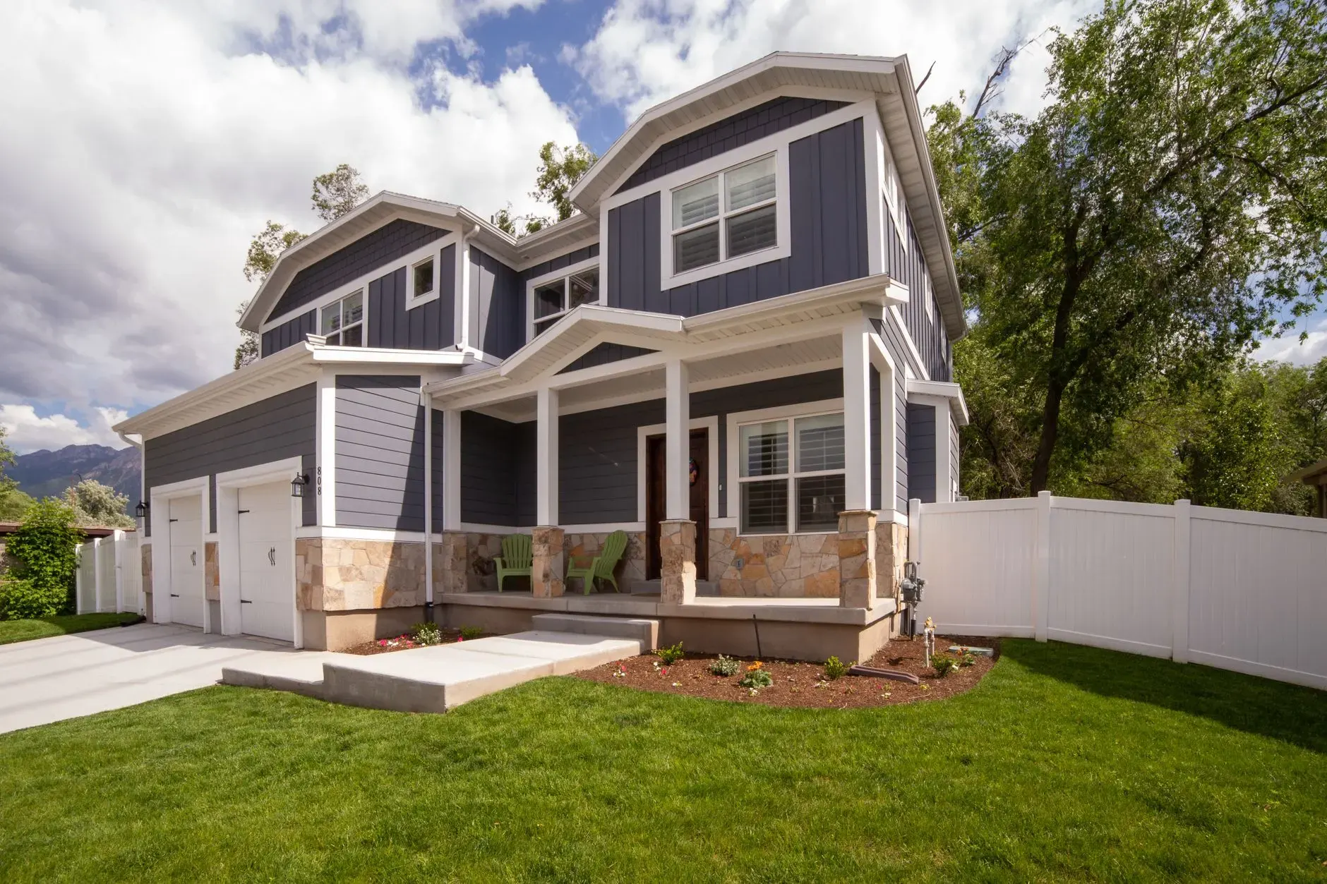 Painting services in Marietta, GA: freshly painted two-story home with a covered porch and attached garage