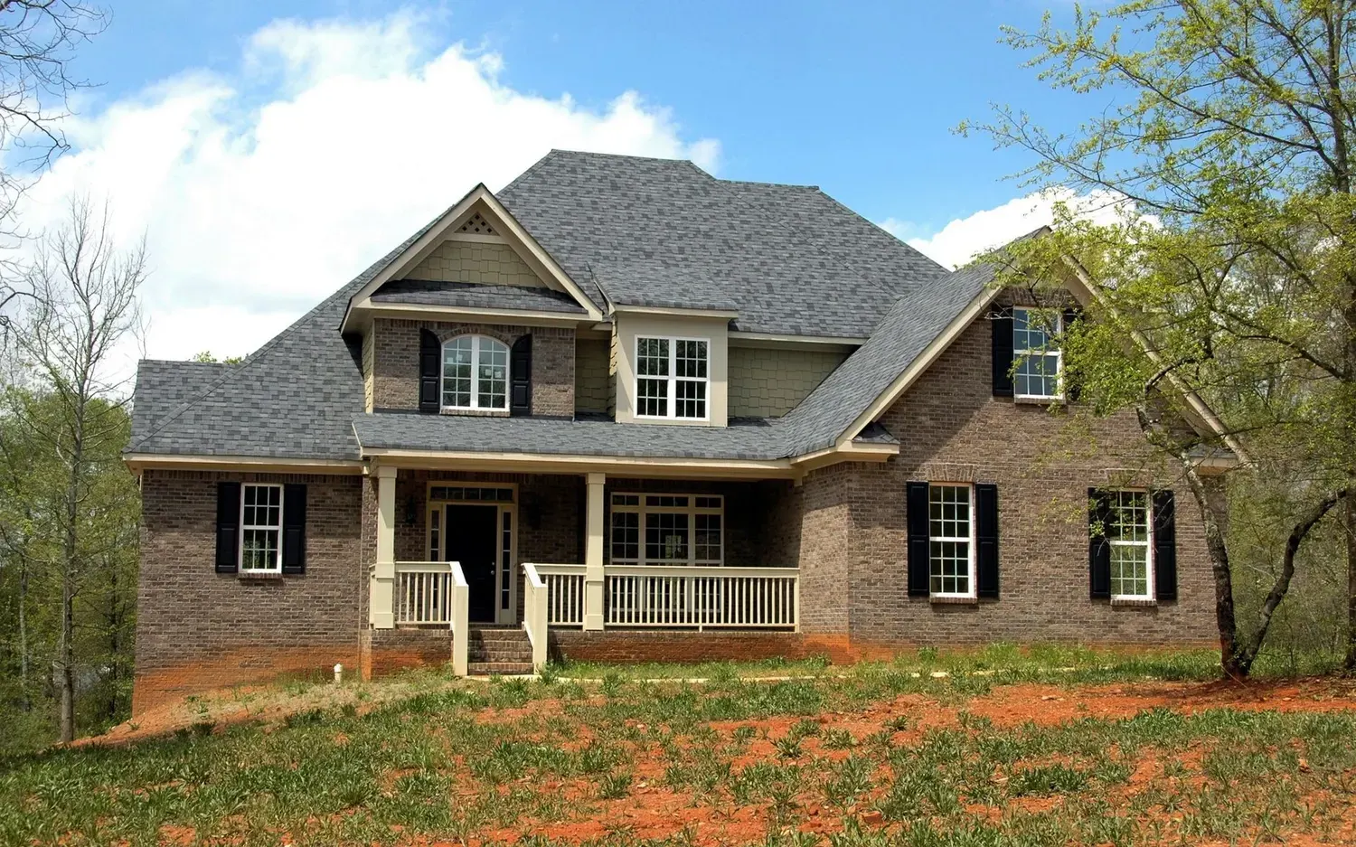Painter in Marietta, GA: two-story brick and siding home with a covered front porch