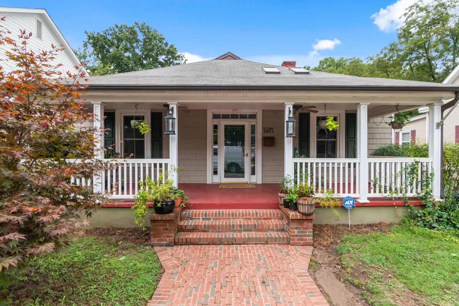 Painter in Smyrna, GA: cottage-style home with a white-railed porch and brick walkway