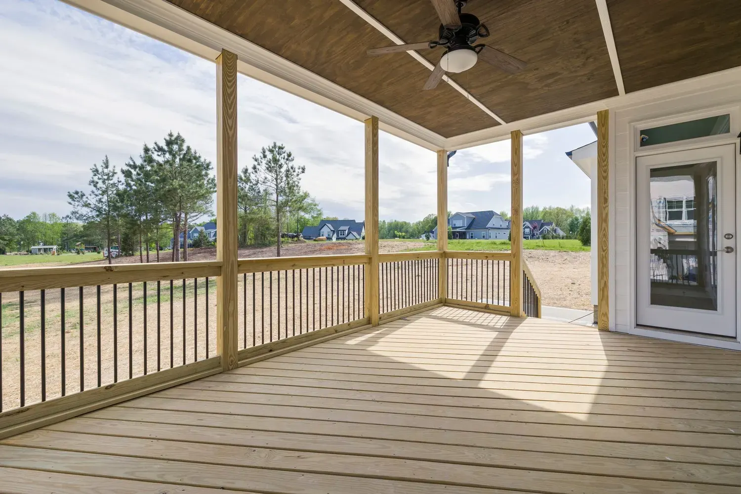 Deck painting in Marietta, GA: covered wood deck with railing overlooking a yard