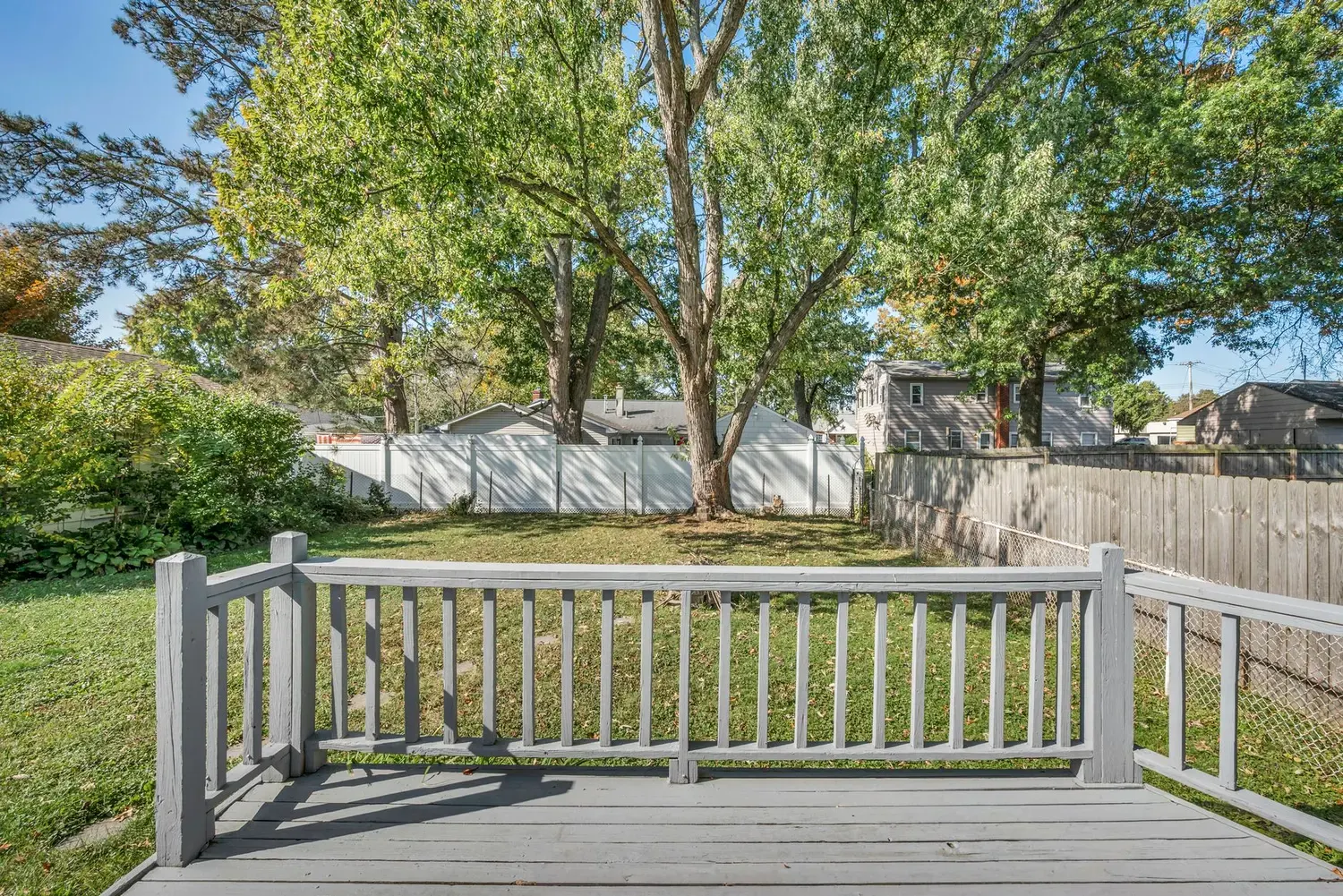 Deck services in Marietta, GA: backyard deck with painted railing and boards